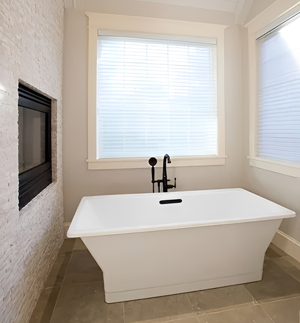 Modern bathroom with rectangular bathtub and windows.