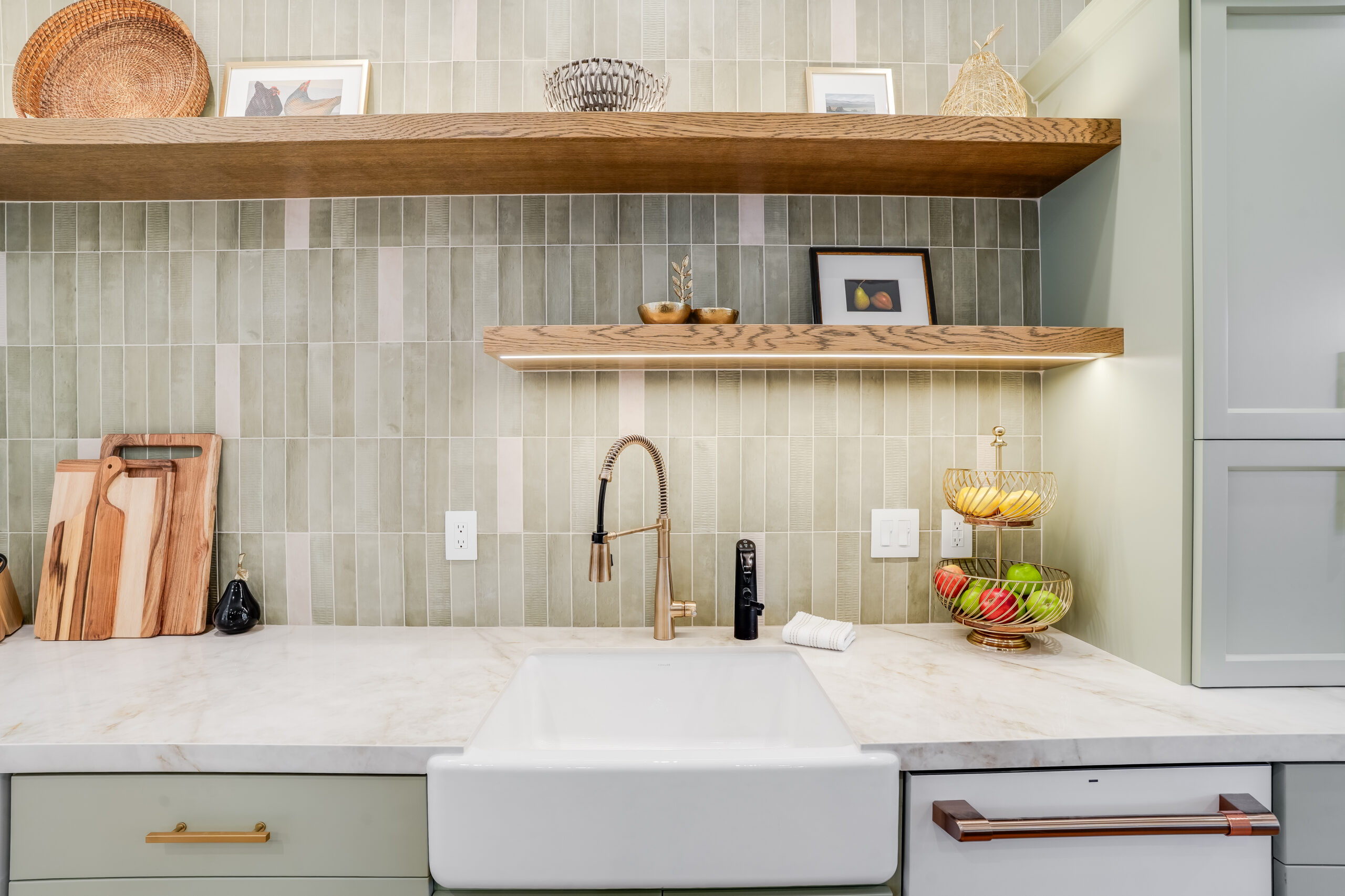 Farmhouse sink with brass faucet and shelves