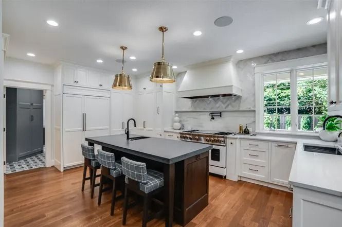 Modern kitchen with island and pendant lights.