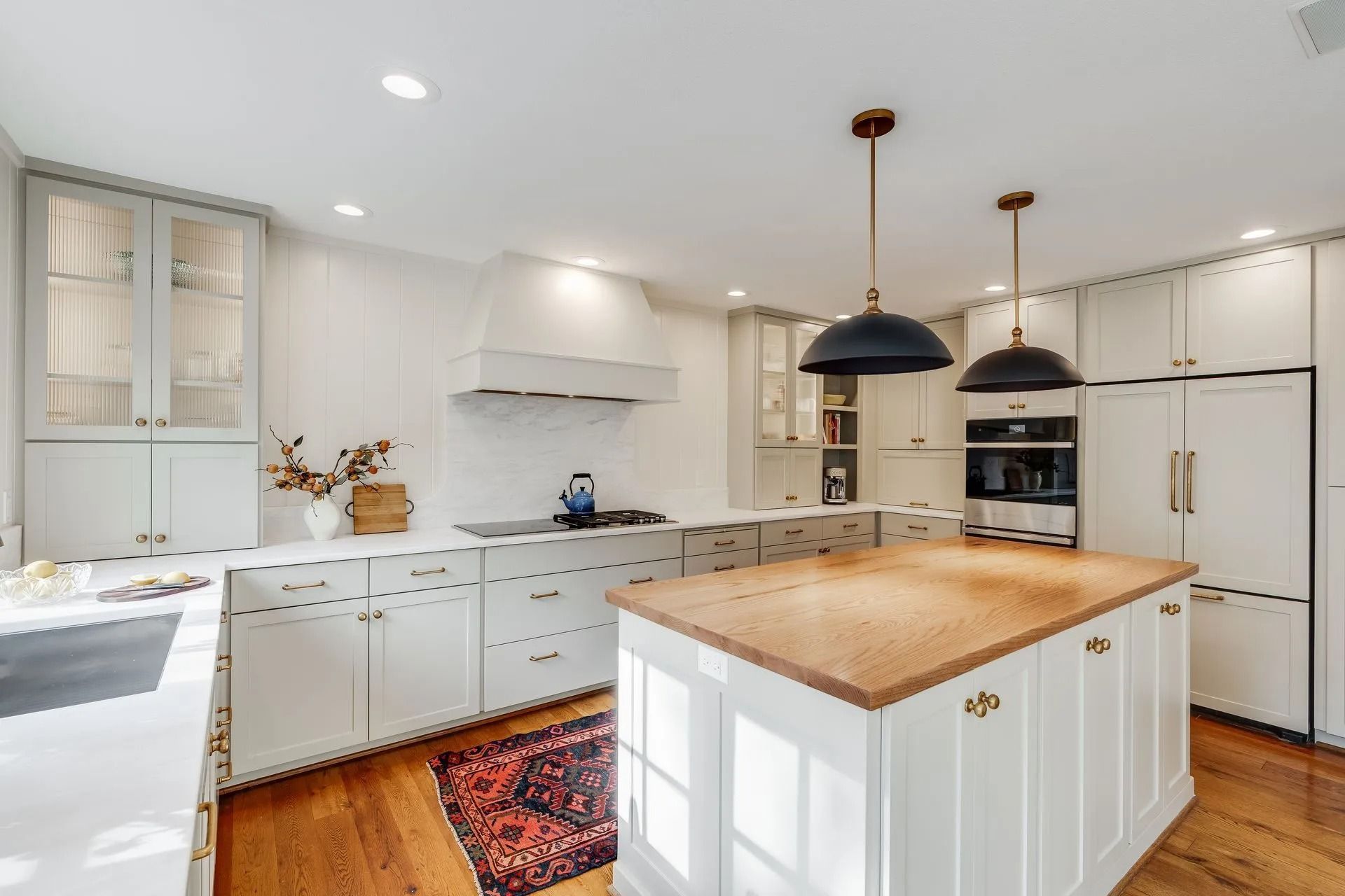 Elegant kitchen featuring white cabinets