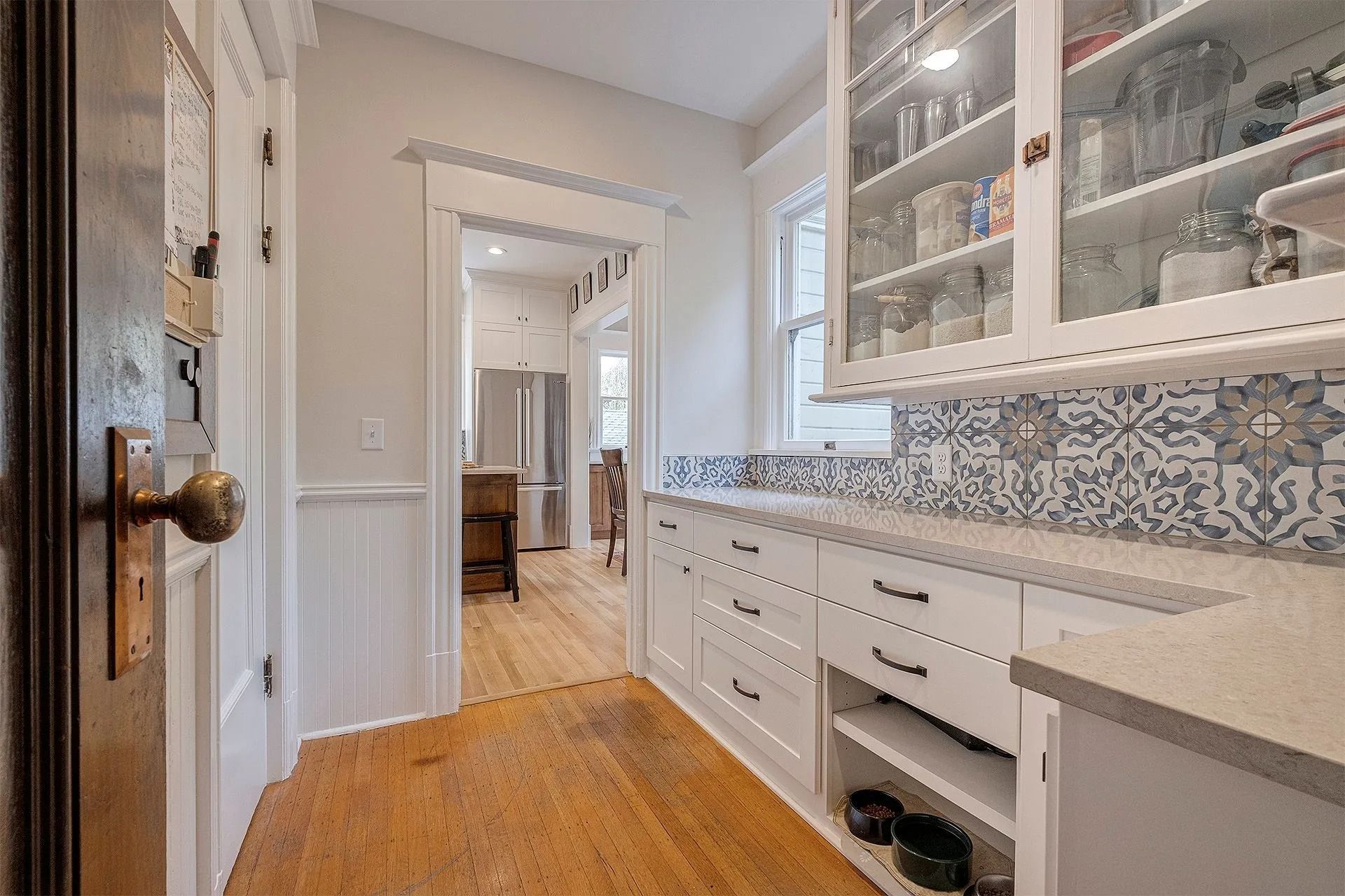 Modern kitchen featuring glass cabinet doors