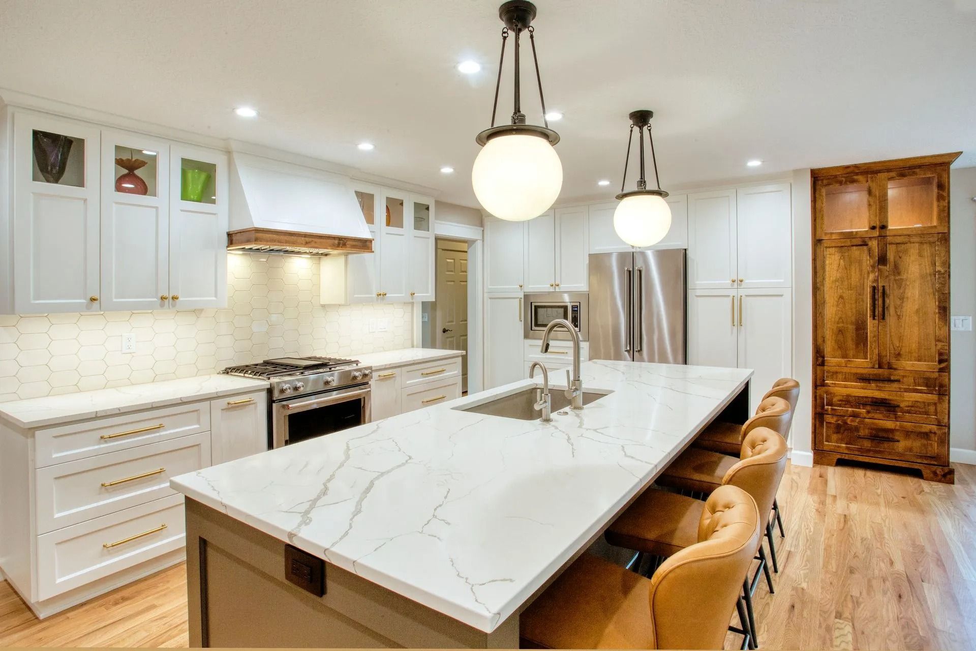 Modern kitchen with marble island and stools