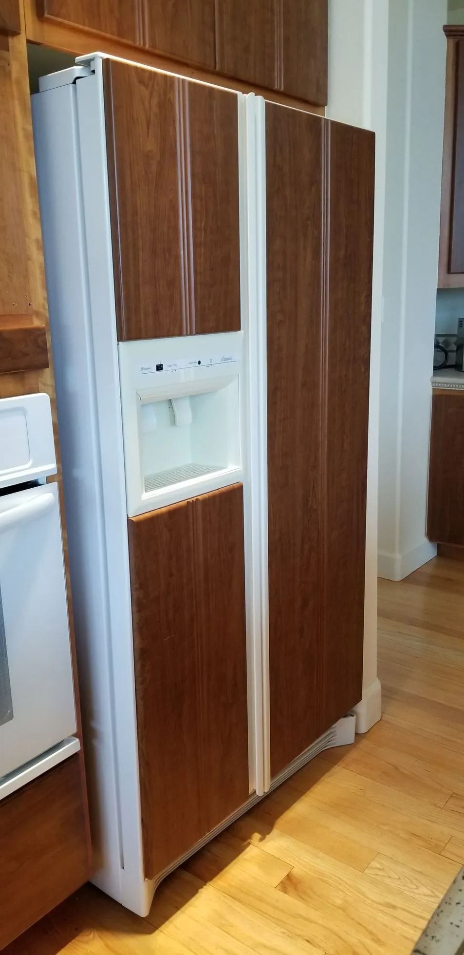 Built-in kitchen refrigerator with wood panels