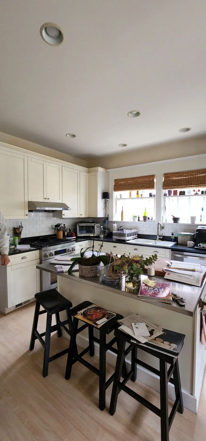 Bright kitchen featuring white cabinets