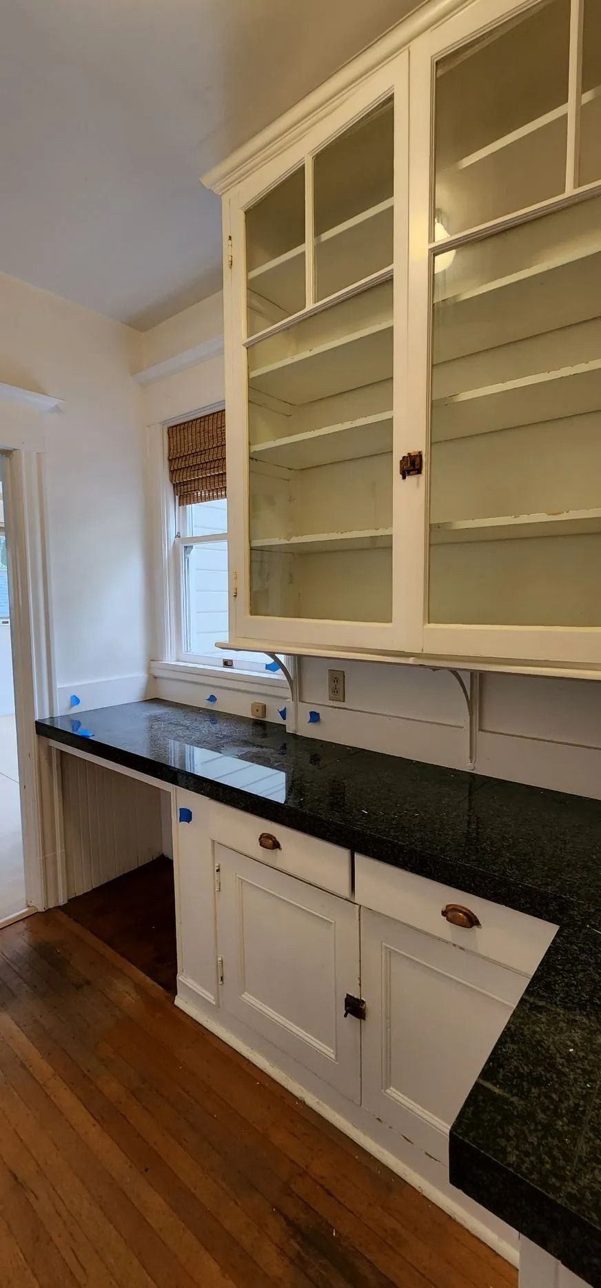 Wooden floor kitchen with white cabinetry
