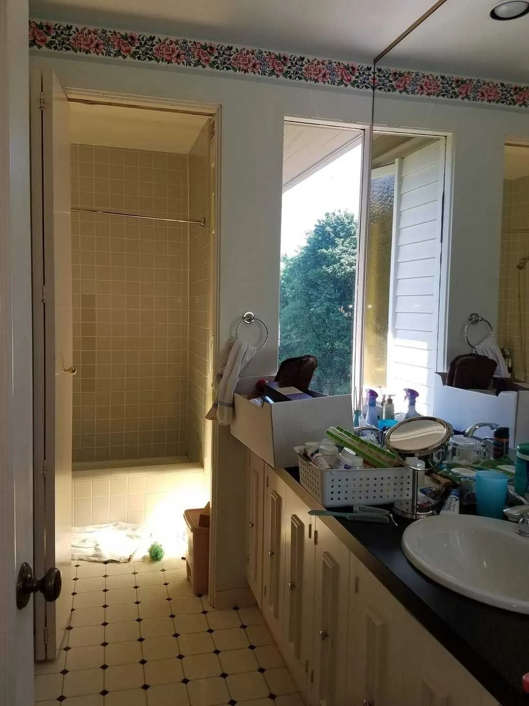 Sunlit bathroom with large mirror