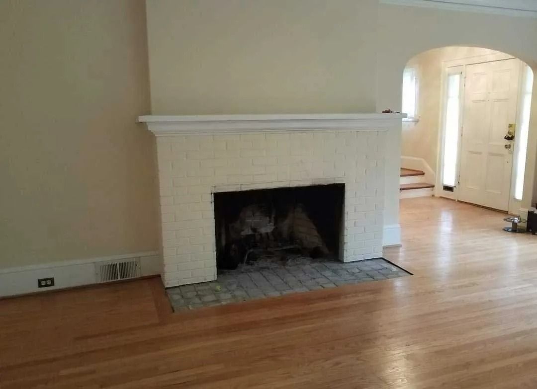Bright room featuring a classic brick fireplace