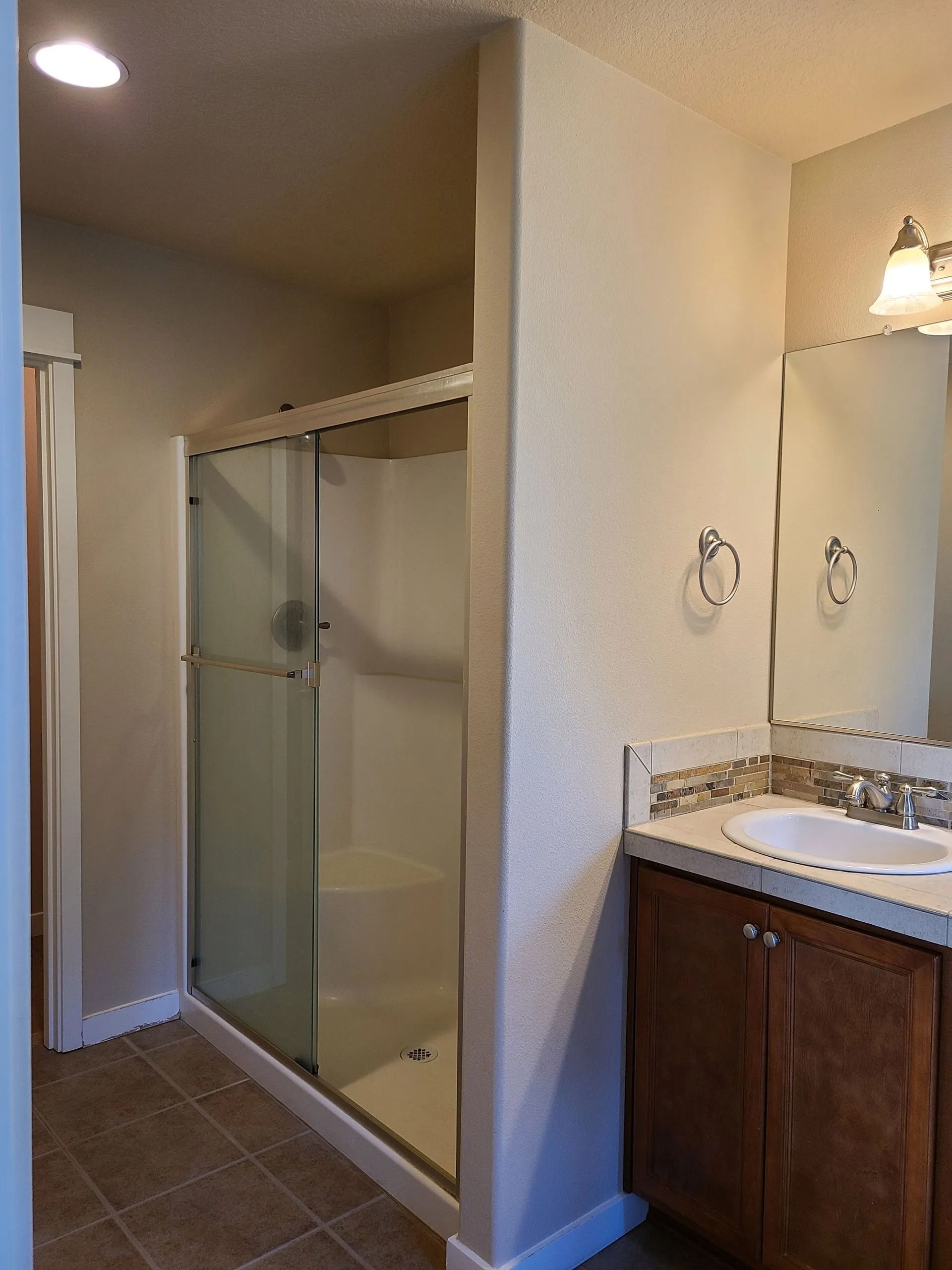 Bathroom vanity and glass shower enclosure