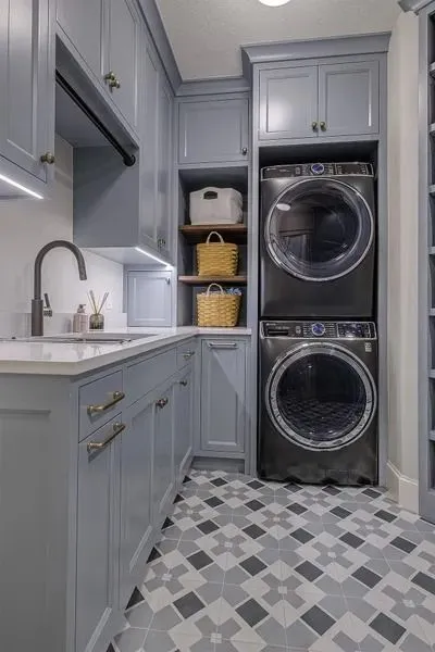 Stylish laundry room with patterned floor tiles