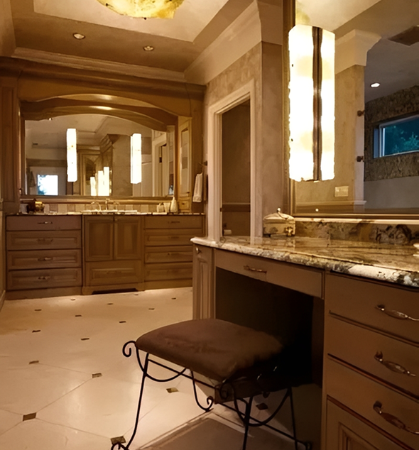 Luxurious bathroom with wooden cabinets and lighting.