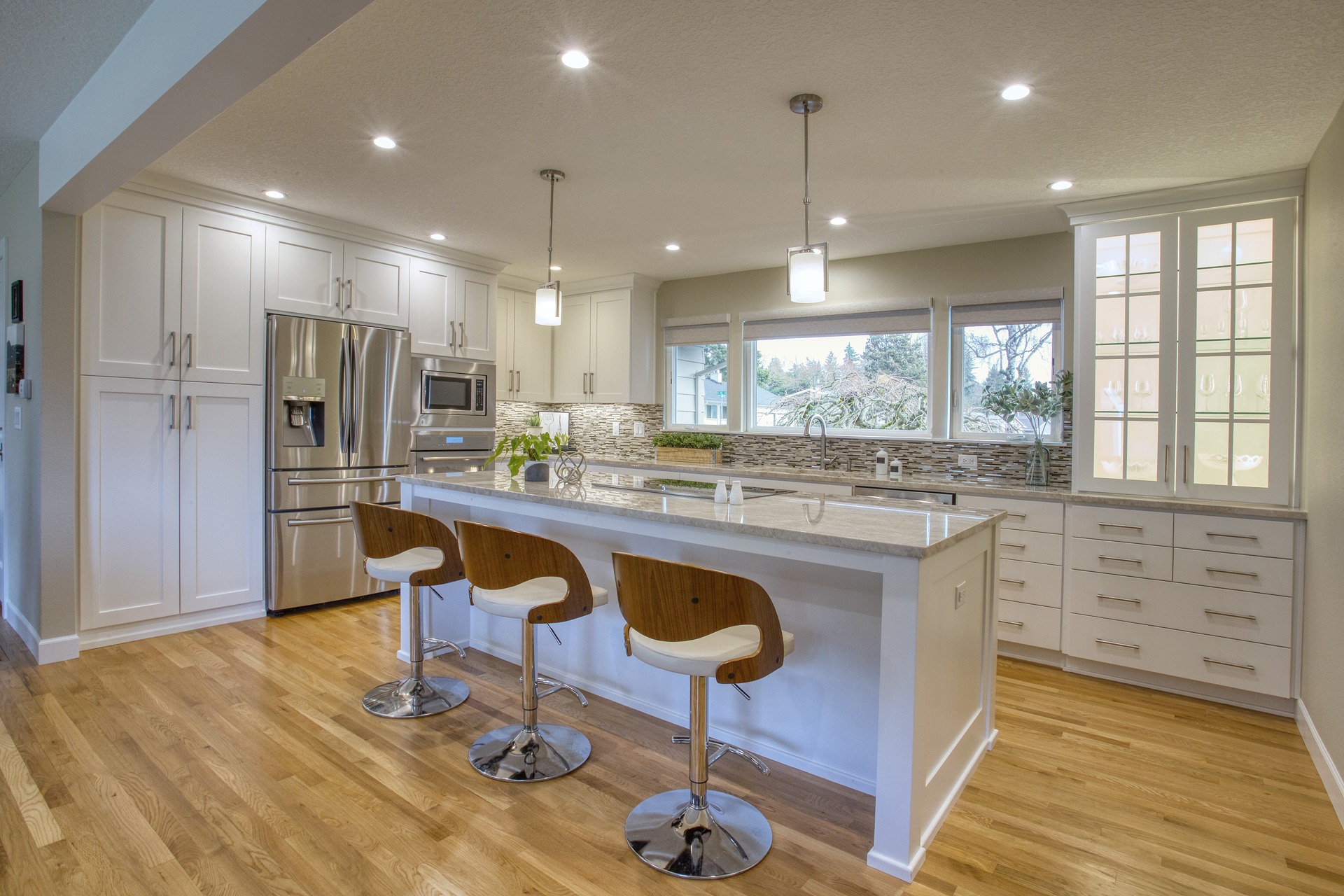 Modern white kitchen with island and stools