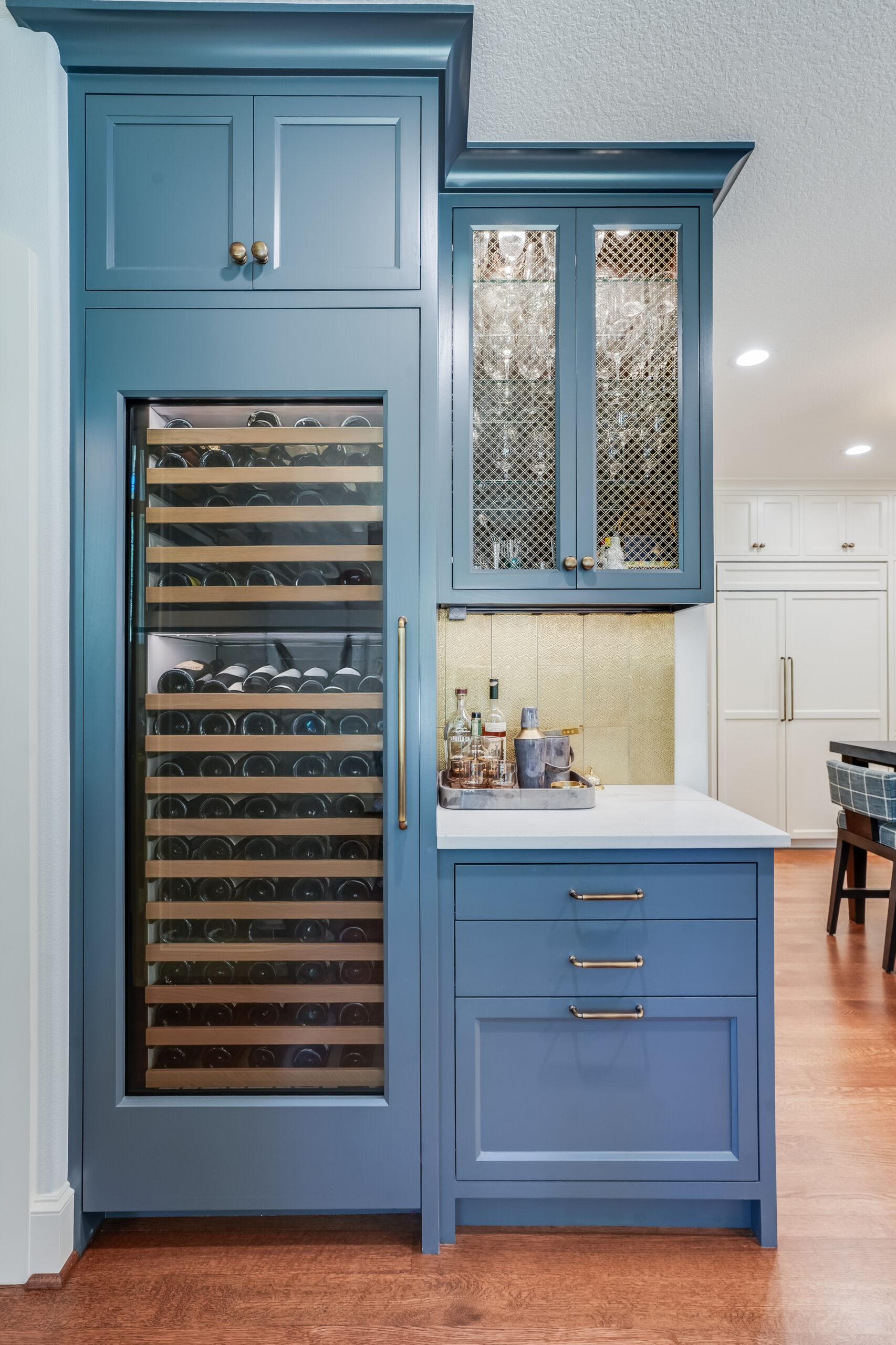 Blue kitchen cabinetry with built-in wine fridge