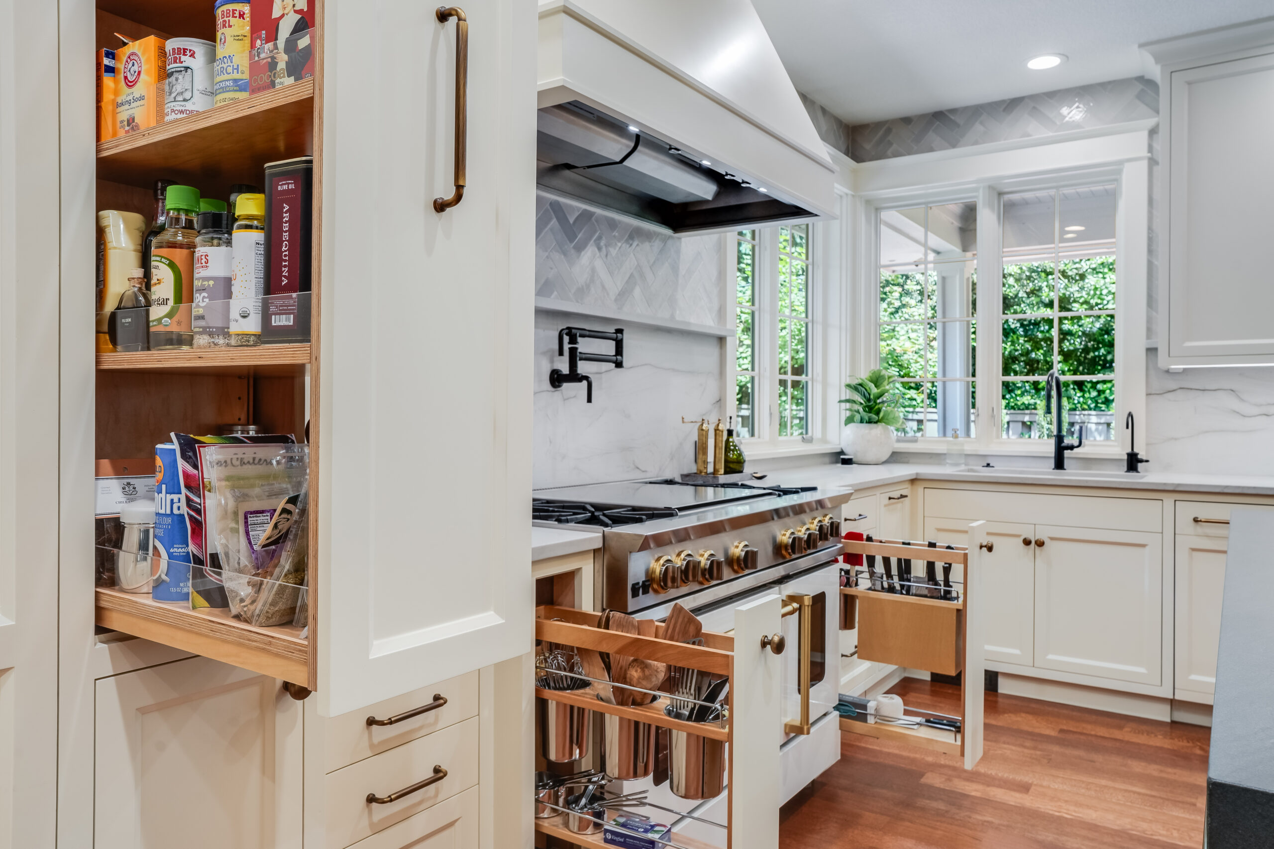 Modern white kitchen with open pantry drawers