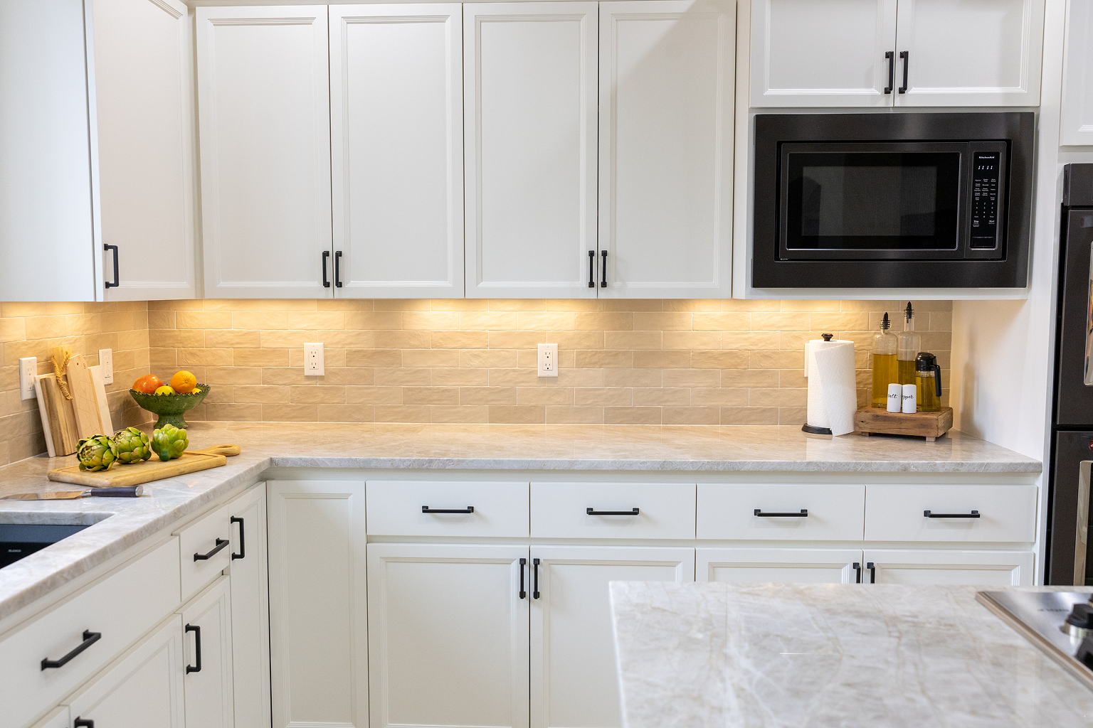 Bright modern white kitchen with marble countertops
