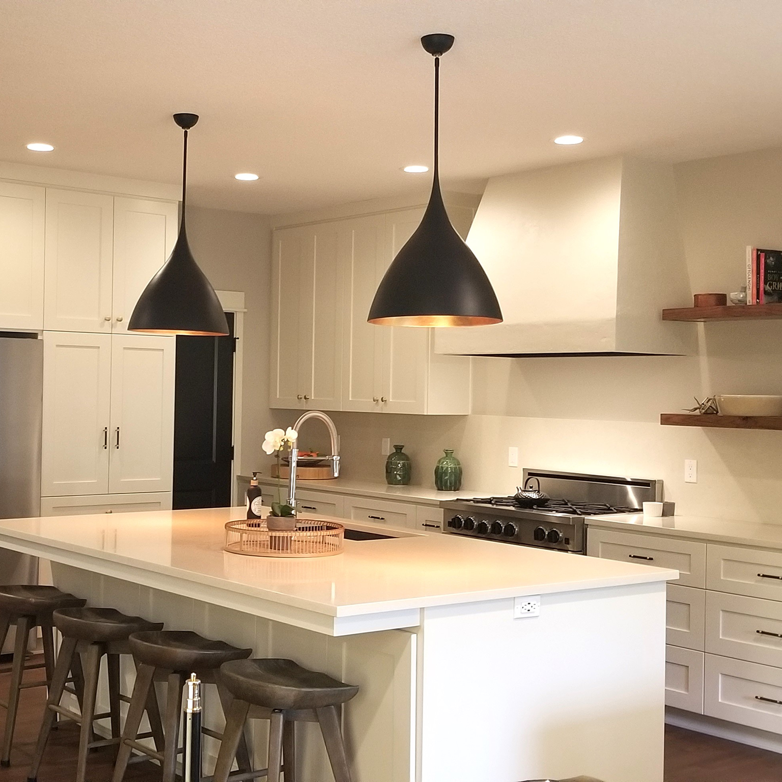 Modern kitchen island with black pendant lights