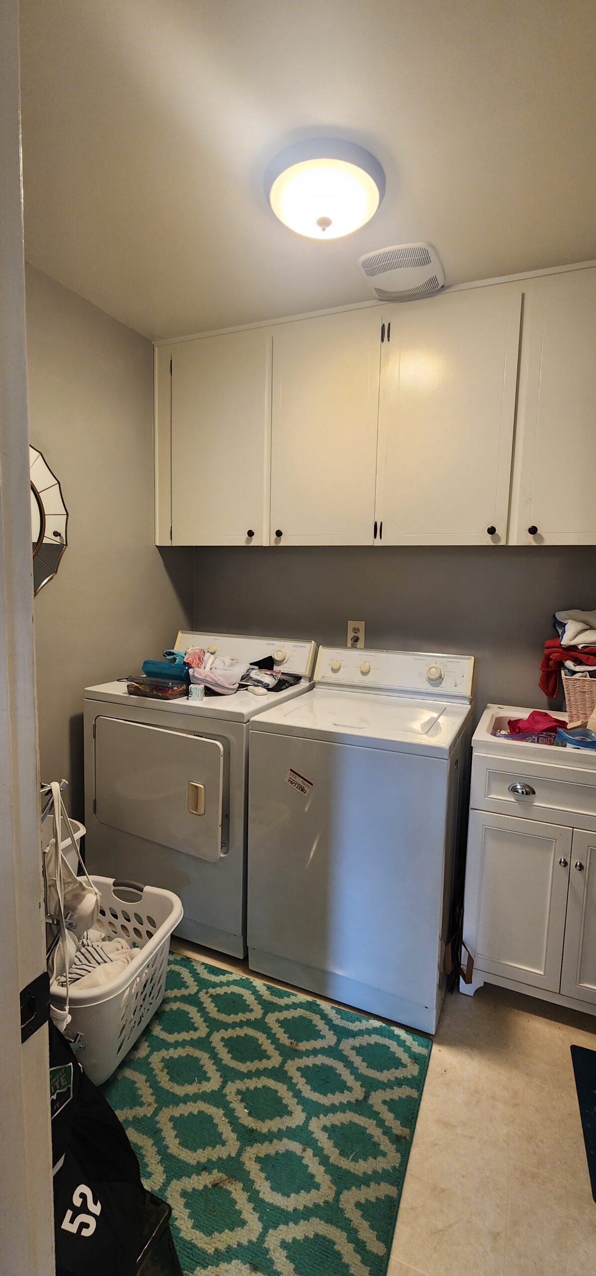 Laundry room with washer, dryer, cabinets