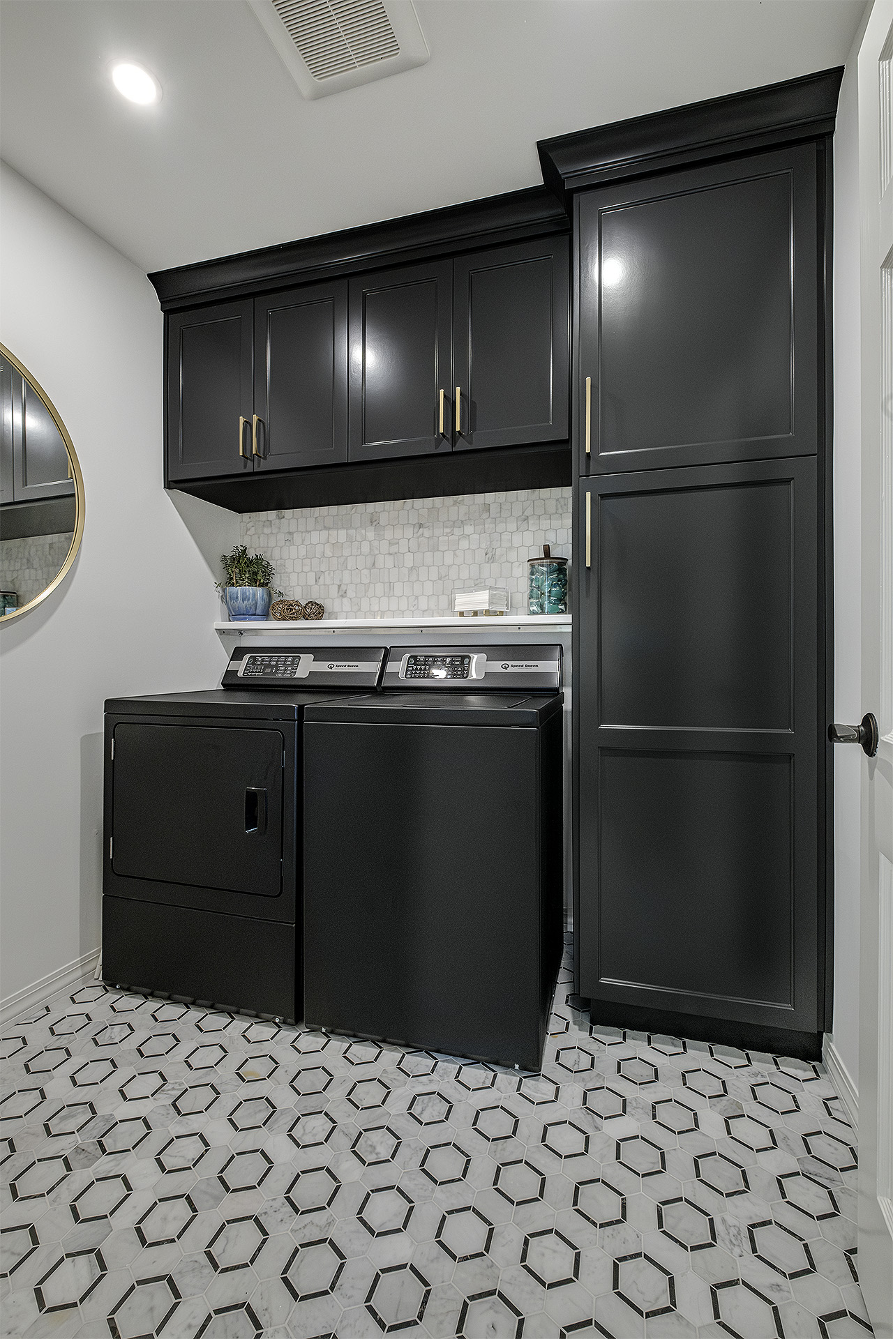 Modern laundry room with black washer and dryer