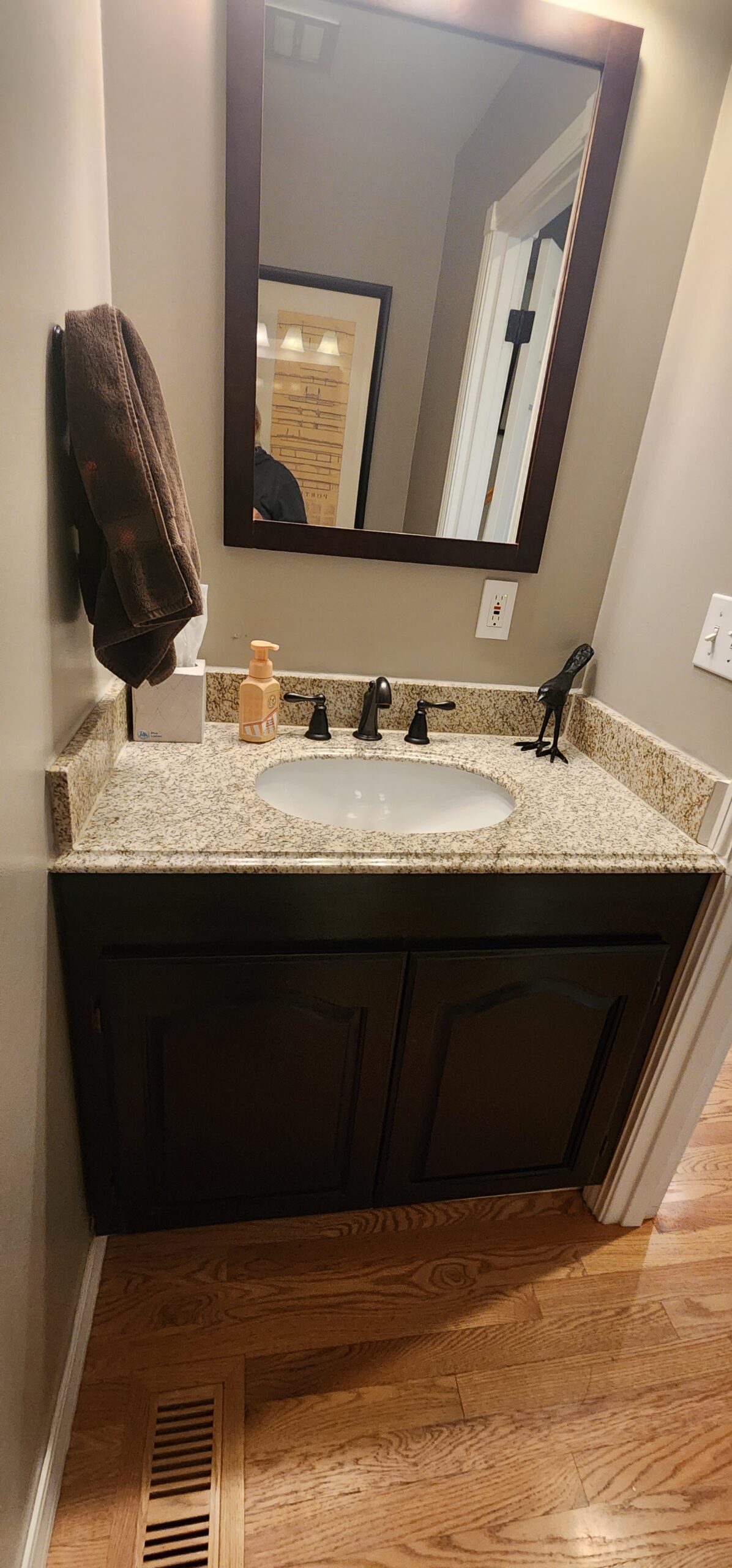 Bathroom vanity with granite countertop and mirror