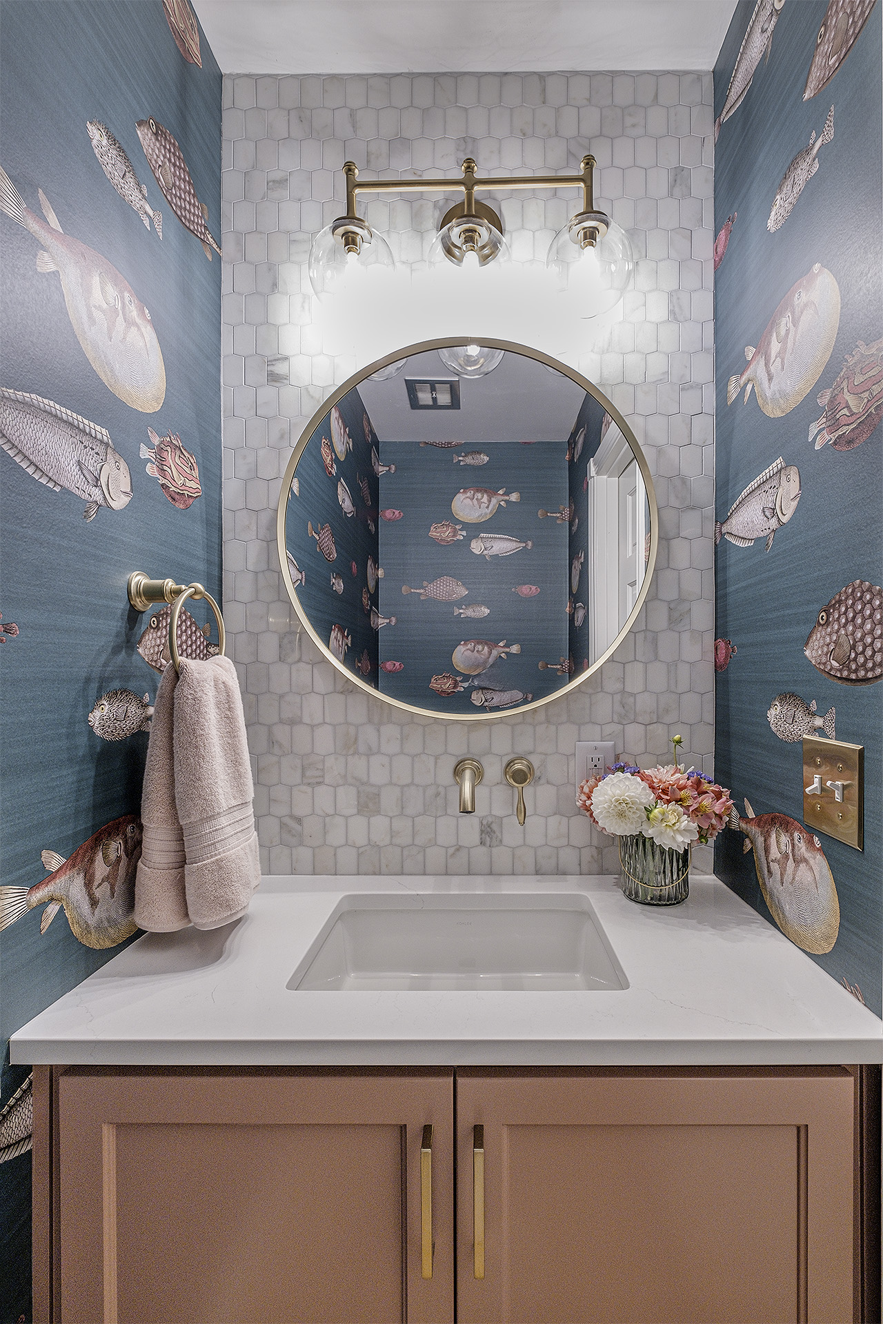 Powder room vanity with round mirror, fish wallpaper