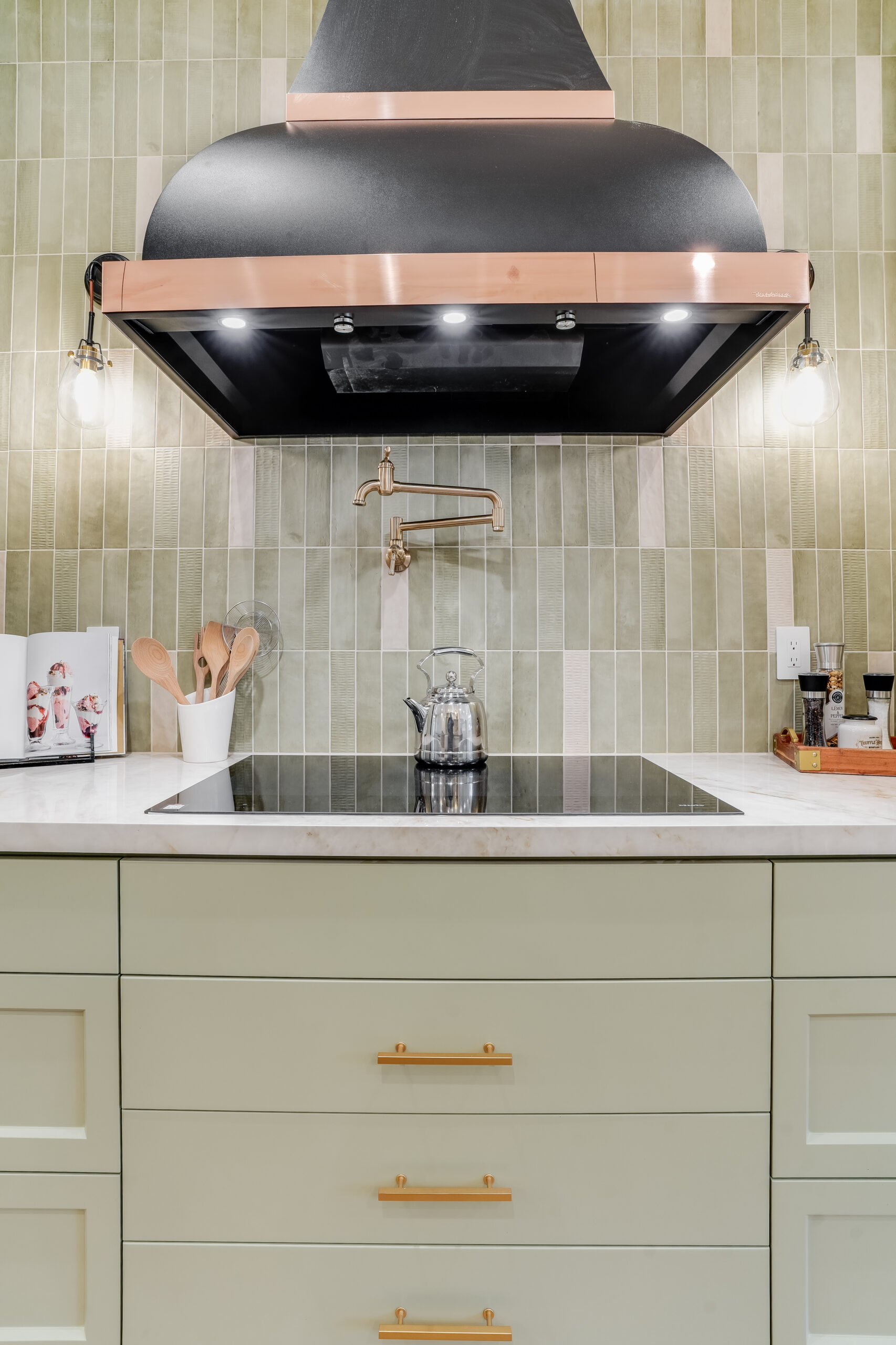 Modern kitchen stovetop with copper range hood