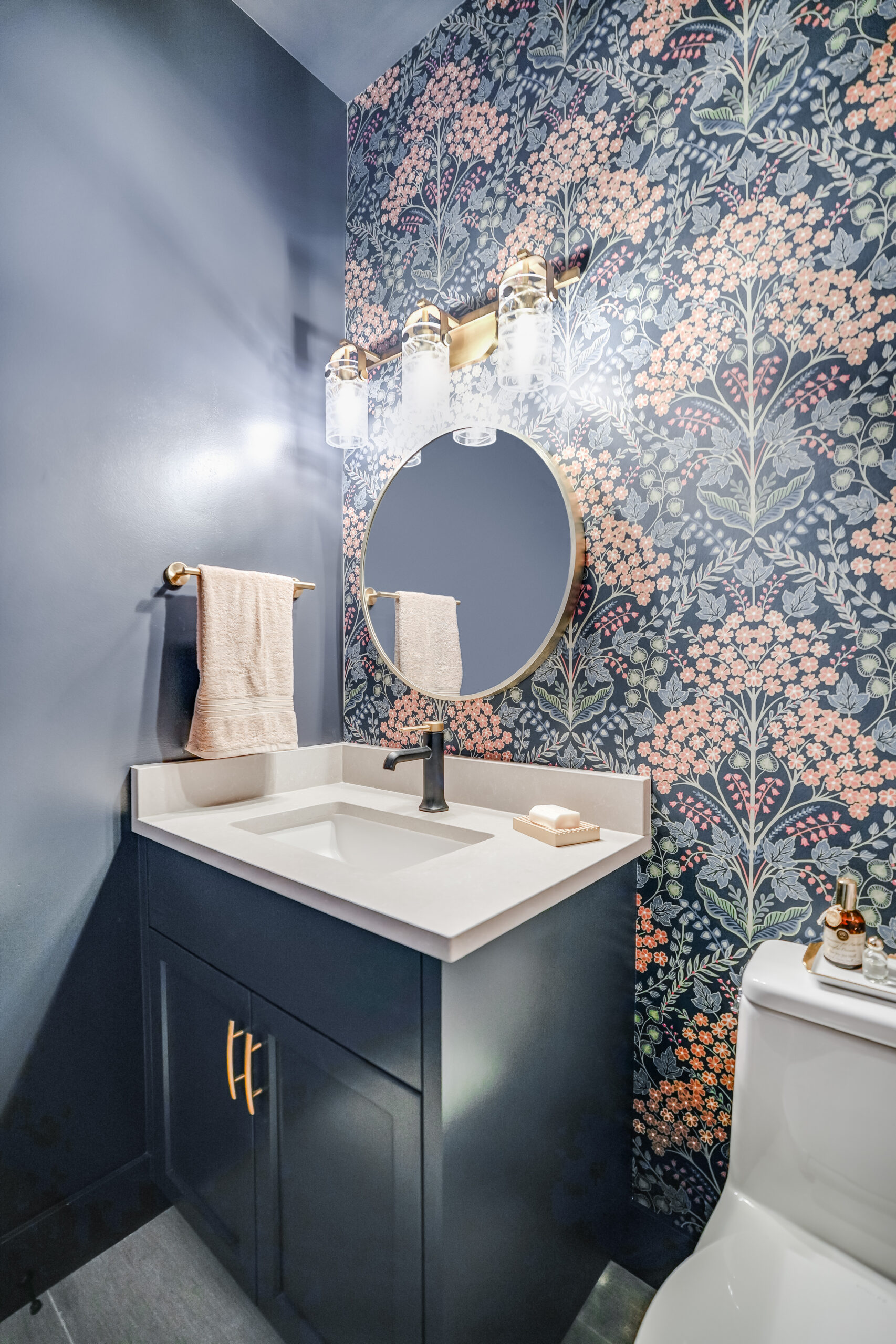 Powder room with floral wallpaper and vanity