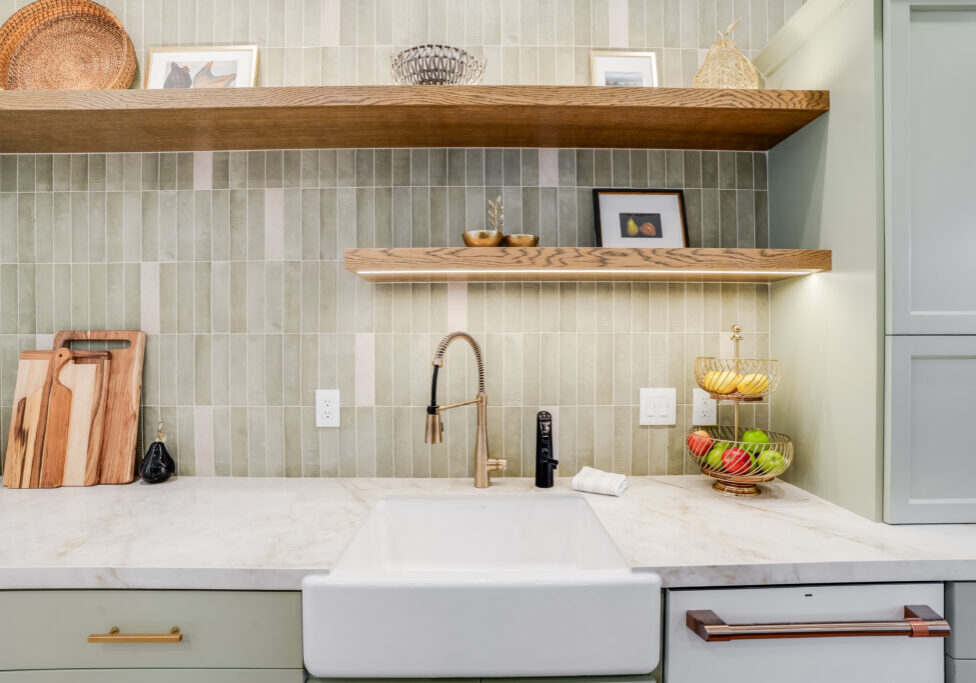 Farmhouse sink with brass faucet and shelves
